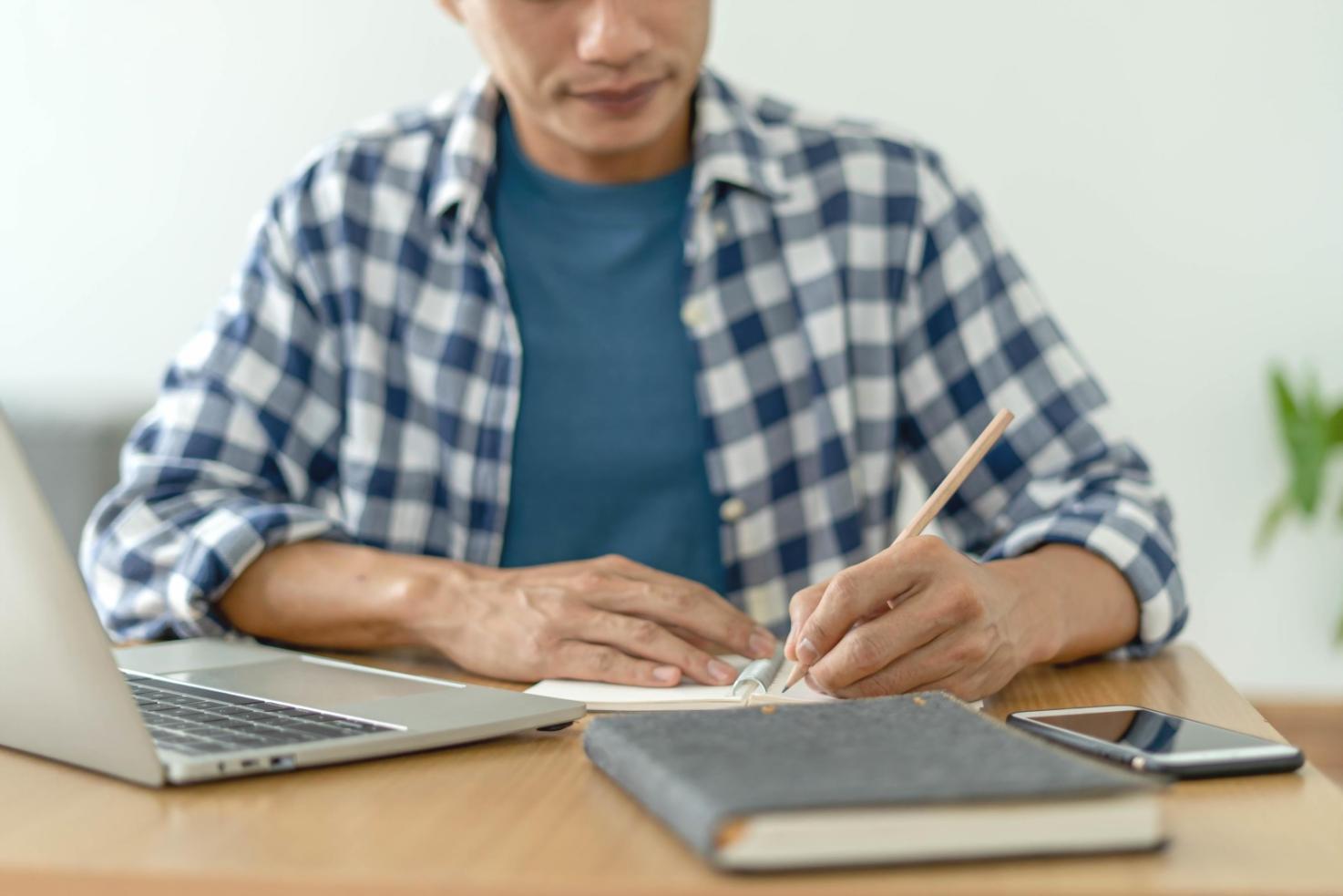 Business meeting with financial documents and laptop showing strategic planning session